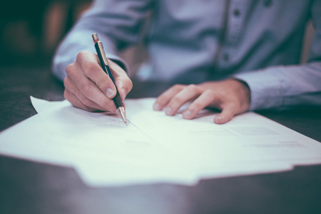 Man signing a broadband contract.