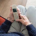 Older person using their home phone.