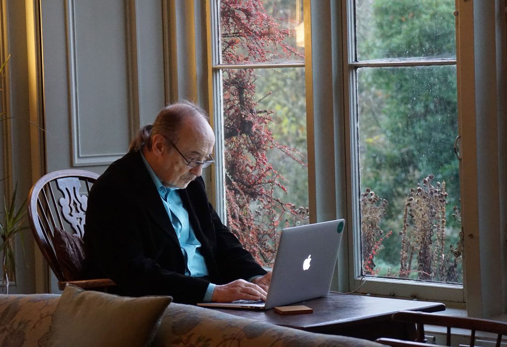 Old person using a Macbook.